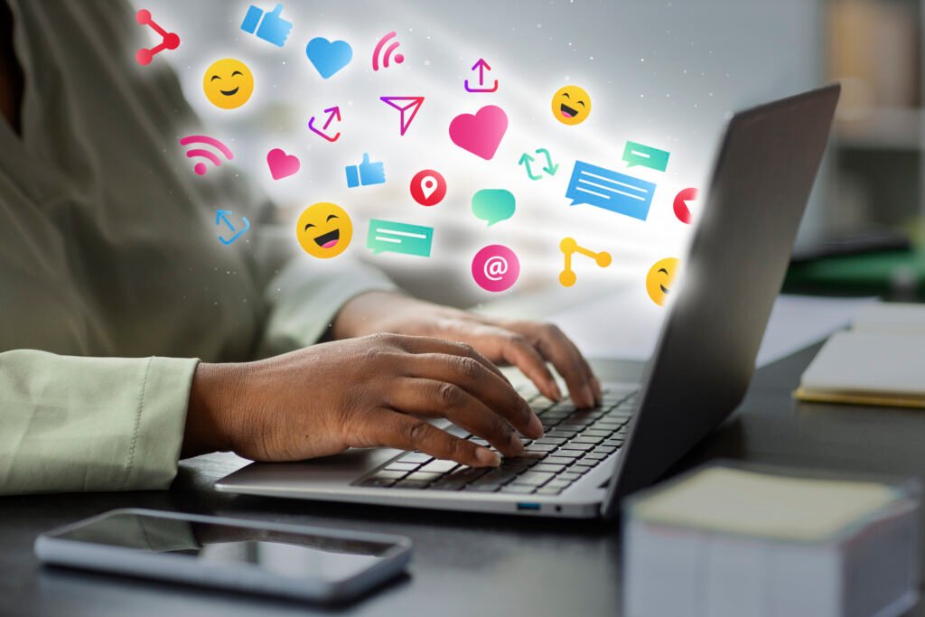How to Grow My Business on Social Media using digital engagement, with a person working on a laptop surrounded by social media icons.