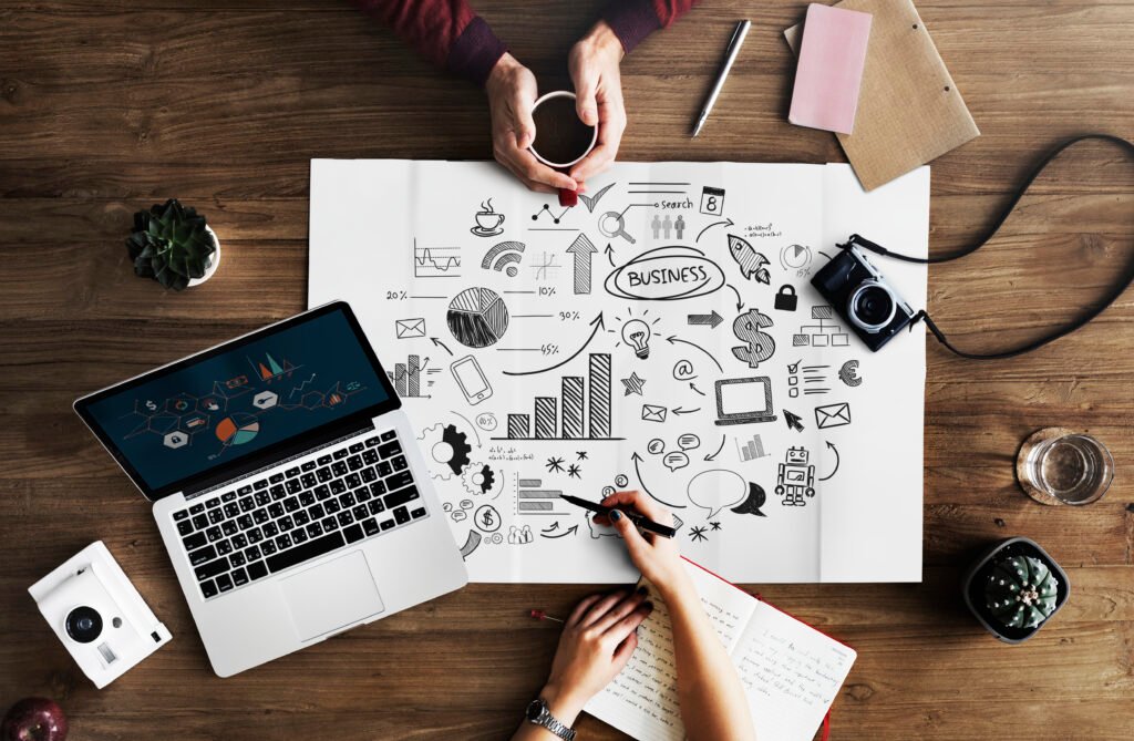 How to Grow My Business on Social Media with a strategic business planning workspace, laptop, analytics sketches, and marketing ideas.